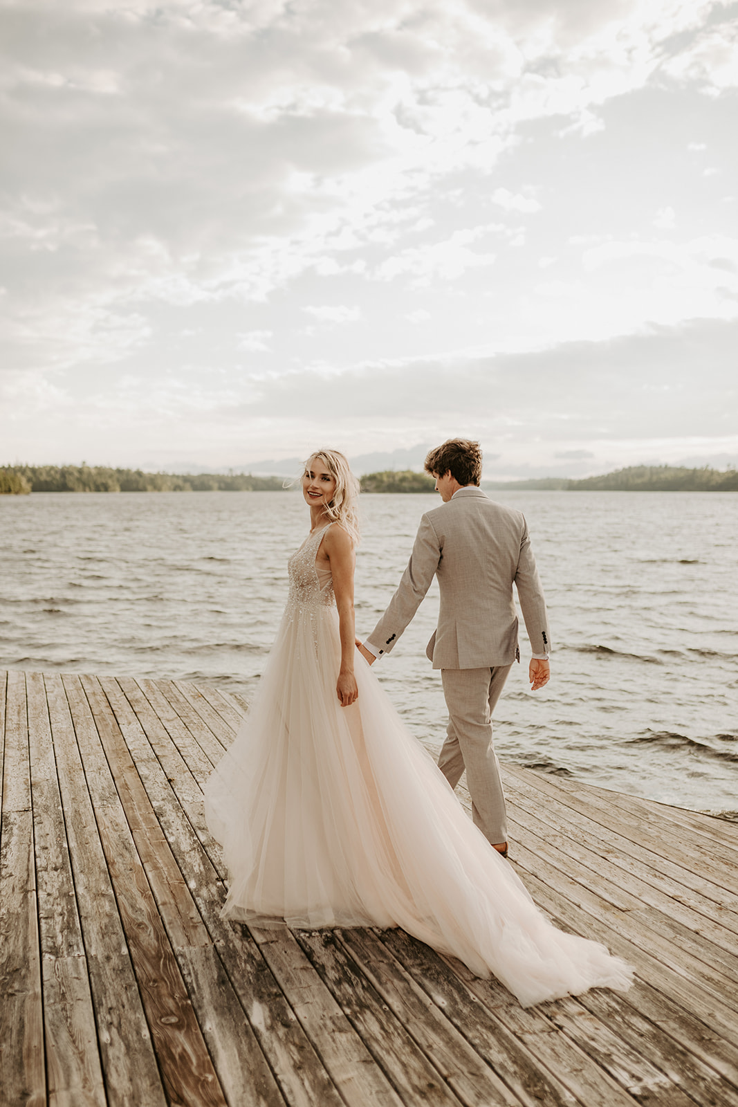 Bride and groom on dock during their ceremony during their wedding in Lake of the Woods, Kenora, Ontario